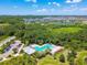 Aerial view of neighborhood pool nestled among green landscape and community buildings at 6218 Magnolia Park Blvd, Riverview, FL 33578