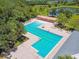 Community pool with a shaded lounge area, patio furniture, fountains, and green space at 6218 Magnolia Park Blvd, Riverview, FL 33578