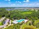 Aerial view of neighborhood pool nestled among green landscape and community buildings at 6218 Magnolia Park Blvd, Riverview, FL 33578