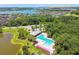 Overhead view of community pool surrounded by lush landscaping, neighborhood homes, and a lake at 6218 Magnolia Park Blvd, Riverview, FL 33578