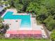 Aerial shot of community pool with water fountains, lounge chairs, umbrellas, and landscaping at 6218 Magnolia Park Blvd, Riverview, FL 33578