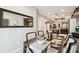 Dining room with a modern glass table, stylish chairs, and an open view of the kitchen at 6218 Magnolia Park Blvd, Riverview, FL 33578