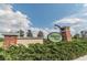Community entrance sign surrounded by brick columns, shrubs, and beautiful sky at 6218 Magnolia Park Blvd, Riverview, FL 33578