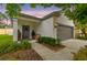 Charming home featuring a gray door with wreath, gray trim, and a two-car garage at 6218 Magnolia Park Blvd, Riverview, FL 33578