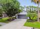 Charming single-story home featuring a gray garage door, manicured landscaping, and a well-maintained lawn at 6218 Magnolia Park Blvd, Riverview, FL 33578