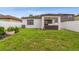 Spacious backyard featuring well-maintained lawn, patio with outdoor kitchen, and secure fencing for added privacy at 6218 Magnolia Park Blvd, Riverview, FL 33578