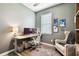 Contemporary home office with a modern desk setup, comfortable chair, and natural light at 6218 Magnolia Park Blvd, Riverview, FL 33578