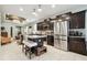 Spacious kitchen boasting stainless steel appliances, a large island, and dark wood cabinetry at 6218 Magnolia Park Blvd, Riverview, FL 33578