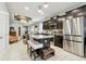 Bright, open kitchen featuring dark cabinets, stainless steel appliances, and granite countertops on the island at 6218 Magnolia Park Blvd, Riverview, FL 33578