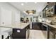 Stylish kitchen featuring a granite island, dark cabinetry, and modern stainless steel appliances at 6218 Magnolia Park Blvd, Riverview, FL 33578