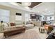 Bright open-plan living room with a sectional sofa, modern decor, and adjacent kitchen at 6218 Magnolia Park Blvd, Riverview, FL 33578