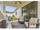 Cozy covered patio with sleek seating, outdoor grill, and sliding glass doors to seamlessly blend indoor-outdoor living at 6218 Magnolia Park Blvd, Riverview, FL 33578
