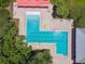 Aerial view of a uniquely shaped community pool with brick surround and lounge furniture at 6218 Magnolia Park Blvd, Riverview, FL 33578