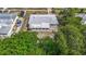 Birds-eye view showcases the home with a new roof, lush trees, and cars parked in the driveway at 6832 Treehaven Dr, Spring Hill, FL 34606