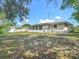 Spacious backyard showcasing the property's outdoor space with an enclosed porch at 6832 Treehaven Dr, Spring Hill, FL 34606