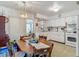 Well-lit kitchen and dining area featuring white cabinets and room for gatherings at 6832 Treehaven Dr, Spring Hill, FL 34606