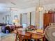 Open dining area with wood table, kitchen access, and a decorative chandelier at 6832 Treehaven Dr, Spring Hill, FL 34606