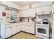 Kitchen with ample counter space, functional appliances, and white cabinets at 6832 Treehaven Dr, Spring Hill, FL 34606