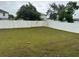 Large, fenced backyard with mature trees, freshly cut grass, and plenty of space for outdoor activities at 9397 Northcliffe Blvd, Spring Hill, FL 34606