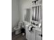 Bright bathroom featuring a vanity, modern fixtures, and a decorated mirror on the wall at 9397 Northcliffe Blvd, Spring Hill, FL 34606