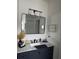 Well-lit bathroom with a marble countertop and modern vanity at 9397 Northcliffe Blvd, Spring Hill, FL 34606