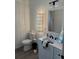 Bright bathroom featuring a vanity, modern fixtures, and a decorated mirror on the wall at 9397 Northcliffe Blvd, Spring Hill, FL 34606