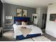 Stylishly decorated bedroom with a blue tufted headboard and fluffy white rug at 9397 Northcliffe Blvd, Spring Hill, FL 34606