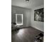 Minimalist bedroom design featuring hardwood floors, art, and natural light, and modern fixtures at 9397 Northcliffe Blvd, Spring Hill, FL 34606