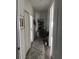 Hallway with hard wood floors and a gray rug connecting different rooms of the house at 9397 Northcliffe Blvd, Spring Hill, FL 34606