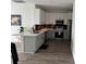 Bright, modern kitchen featuring stainless steel appliances and gray and white cabinets at 9397 Northcliffe Blvd, Spring Hill, FL 34606