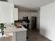 Modern kitchen featuring gray lower cabinets, stainless steel appliances, and a center island at 9397 Northcliffe Blvd, Spring Hill, FL 34606