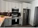Updated kitchen featuring stainless steel appliances and two-tone cabinets at 9397 Northcliffe Blvd, Spring Hill, FL 34606