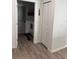 A view into the laundry room with a white door, a laundry mat, and hard wood floors at 9397 Northcliffe Blvd, Spring Hill, FL 34606