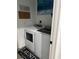 Laundry room with modern appliances, decorated walls, and a sleek design at 9397 Northcliffe Blvd, Spring Hill, FL 34606