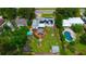 Home in aerial shot shows pool, deck with gazebo, lush backyard and perimeter with fence at 101 N Corona Ave, Clearwater, FL 33765
