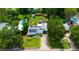 An aerial shot showcases the home's layout, with a long drive, pool and deck, solar and expansive backyard at 101 N Corona Ave, Clearwater, FL 33765