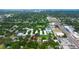 A distant aerial view shows the home nestled in a wooded area with mature trees and city view at 101 N Corona Ave, Clearwater, FL 33765