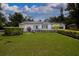 Well-manicured lawn and landscaping enhance this home's curb appeal; white picket fence adds a touch of charm at 101 N Corona Ave, Clearwater, FL 33765