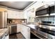 Well-equipped kitchen features stainless steel appliances, tile backsplash, and ample counter space for cooking at 101 N Corona Ave, Clearwater, FL 33765