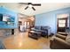 Cozy living room with adjacent kitchen view, featuring wood floors, neutral colors, and open floor plan at 101 N Corona Ave, Clearwater, FL 33765