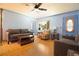 Comfortable living room featuring hardwood floors, a ceiling fan, neutral-toned furniture, and natural light at 101 N Corona Ave, Clearwater, FL 33765