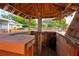 Outdoor bar area with wooden cabinetry, a sink, and license plates for a rustic, entertaining space at 101 N Corona Ave, Clearwater, FL 33765