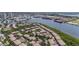 Overhead view of waterfront condo complex with a private pool, tennis courts, parking, and lush landscaping at 1107 Normandy Trace Rd, Tampa, FL 33602