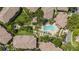 Overhead view of condo complex showing the pool, patio, spa, walkways, lush landscaping, and surrounding residences at 1107 Normandy Trace Rd, Tampa, FL 33602