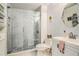 Updated bathroom featuring a glass enclosed shower with decorative tile, a white vanity, and modern fixtures at 1107 Normandy Trace Rd, Tampa, FL 33602
