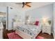 Tranquil bedroom features hardwood floors, natural lighting, and white furniture, creating a peaceful retreat at 1107 Normandy Trace Rd, Tampa, FL 33602