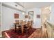 Cozy dining room features a wood table with seating for six, a decorative mirror, and hardwood floors at 1107 Normandy Trace Rd, Tampa, FL 33602