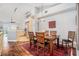 Open concept dining area connected to the kitchen features modern lighting, hardwood floors, and seating for four at 1107 Normandy Trace Rd, Tampa, FL 33602