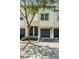 Inviting two-story townhome featuring an attached garage, neutral paint, and well-maintained landscaping at 1107 Normandy Trace Rd, Tampa, FL 33602