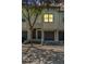 Beautiful condo exterior showcasing a private single car garage, front door, and manicured landscaping at 1107 Normandy Trace Rd, Tampa, FL 33602